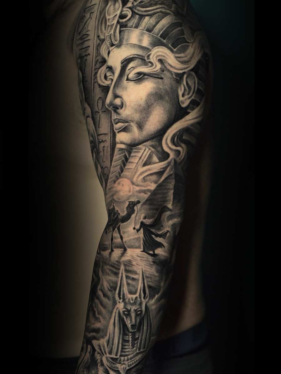 Black-and-grey Egyptian-themed full sleeve tattoo with pharaoh, camel and Anubis